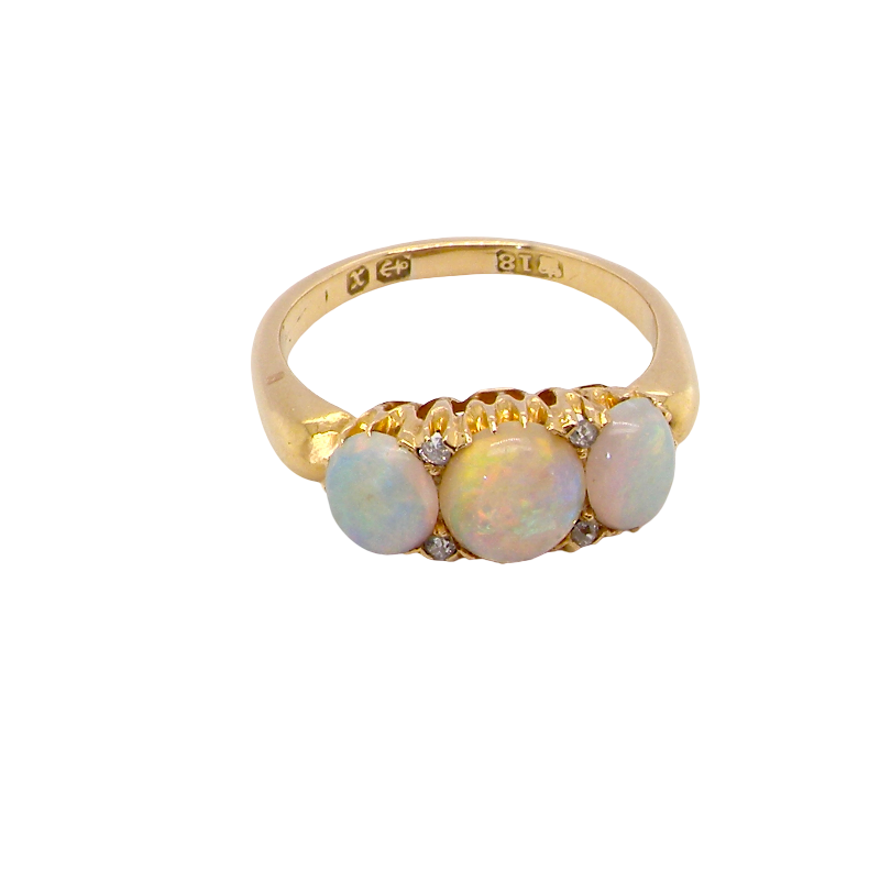 A yellow gold ring featuring three round iridescent white opal gemstones and small clear accent stones, shown on a plain white background.
