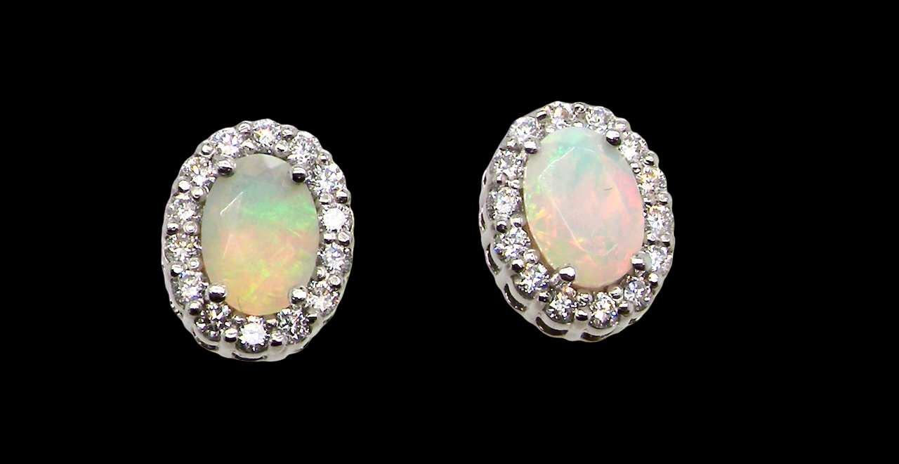 A fine and elegant pair of platinum* stud earrings, each beautifully set with an exceptional white opal