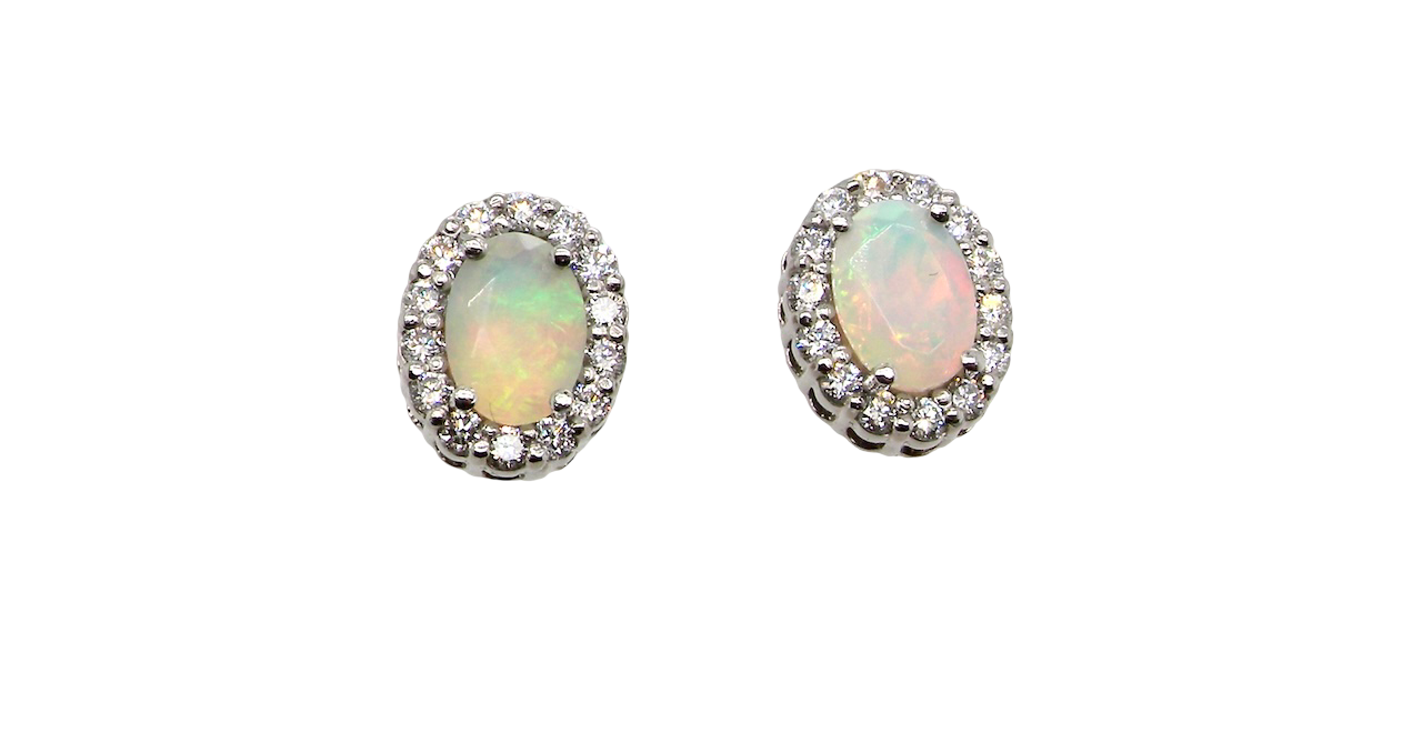 A fine and elegant pair of platinum* stud earrings, each beautifully set with an exceptional white opal measuring 7 x 5mm. T