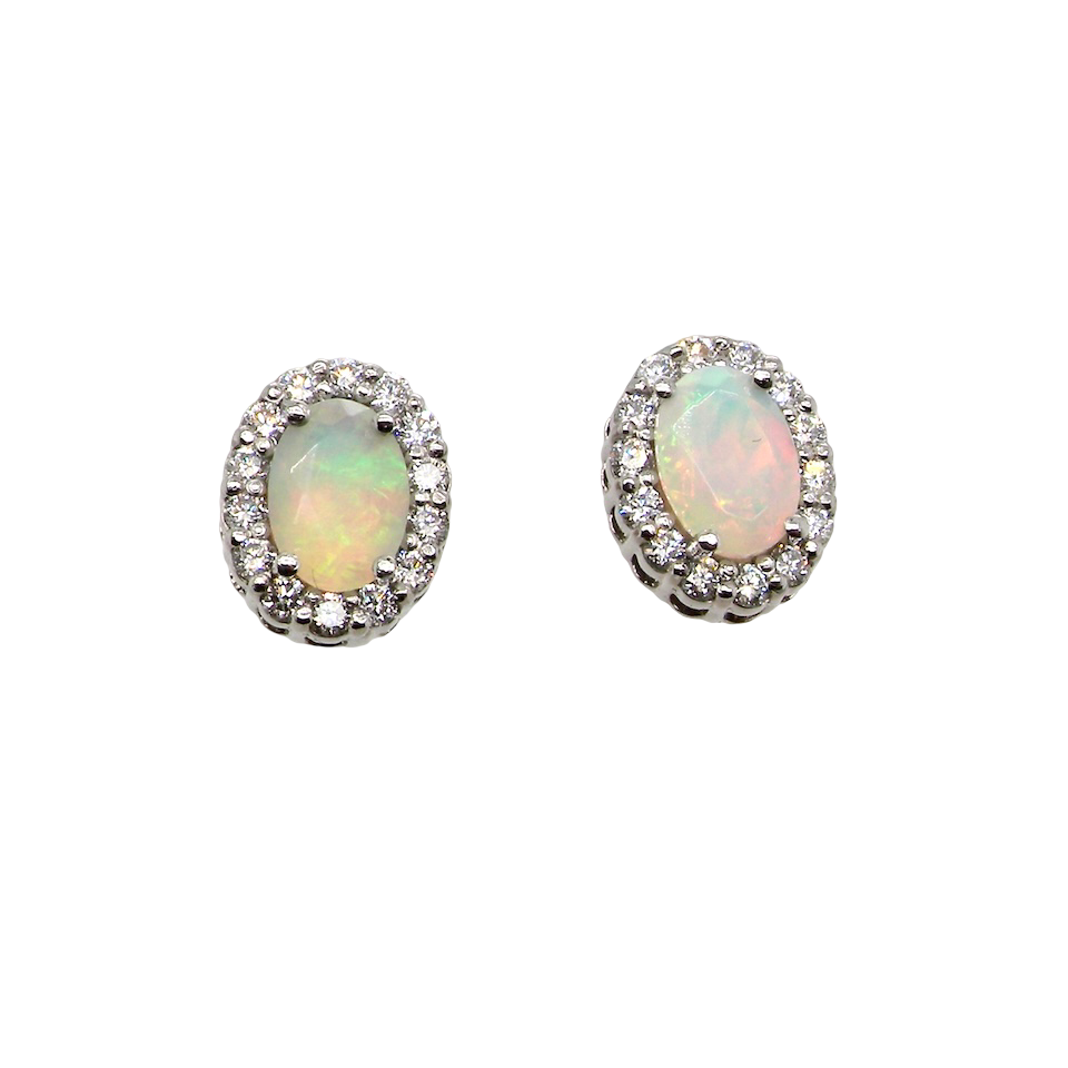 A fine and elegant pair of platinum* stud earrings, each beautifully set with an exceptional white opal measuring 7 x 5mm. T