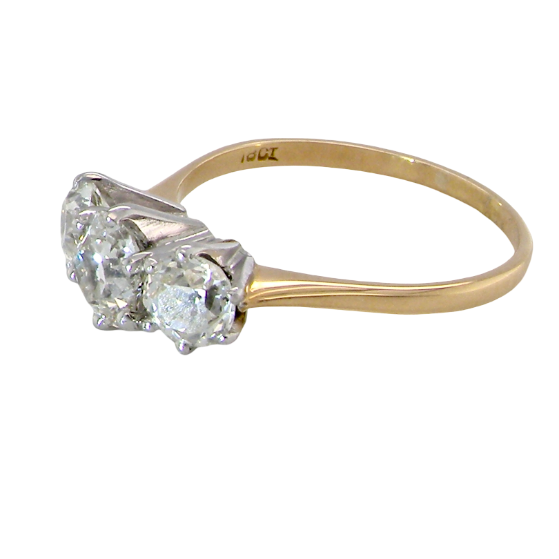 A three-stone diamond ring with a yellow gold band and silver-toned prong setting, shown on a plain white background.