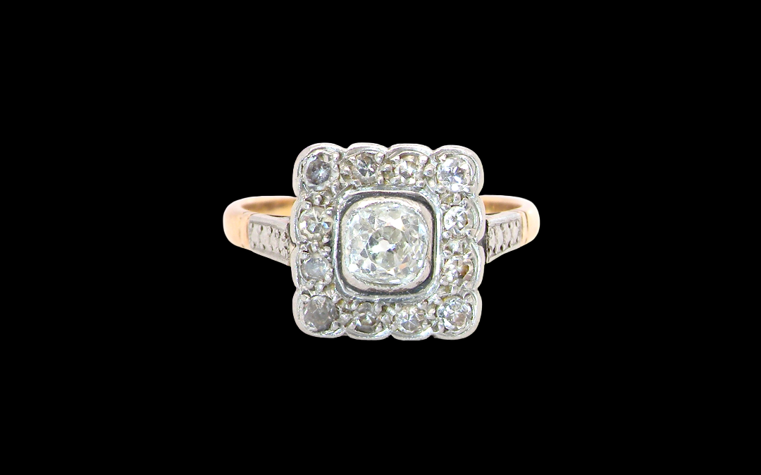 A fine antique ring from the early part of the 20th century (probably 1915-1925)
A square head that measures 11x11mm is set with old brilliant cut white diamonds. The principal stone measures just over half a carat colour i-l, clarity Si, rim setting, platinum.