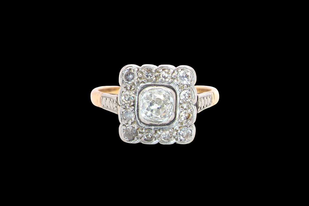 A fine antique ring from the early part of the 20th century (probably 1915-1925)
A square head that measures 11x11mm is set with old brilliant cut white diamonds. The principal stone measures just over half a carat colour i-l, clarity Si, rim setting, platinum.