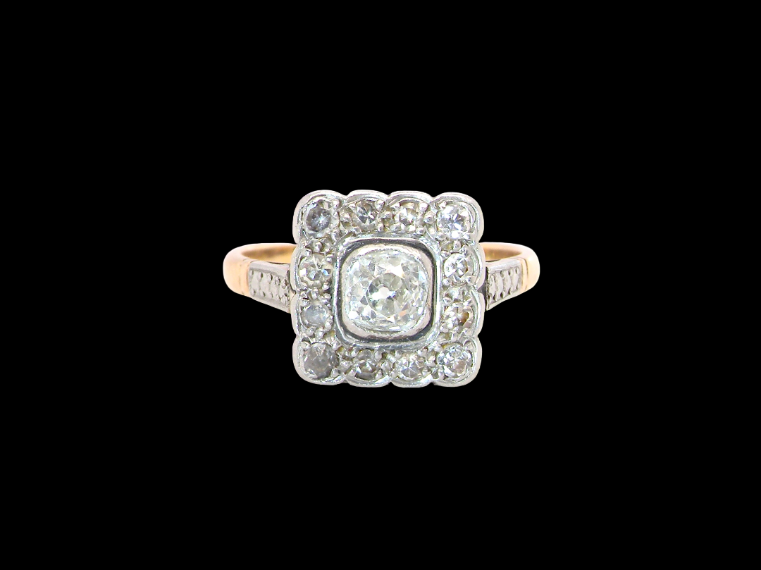 A fine antique ring from the early part of the 20th century (probably 1915-1925)
A square head that measures 11x11mm is set with old brilliant cut white diamonds. The principal stone measures just over half a carat colour i-l, clarity Si, rim setting, platinum.