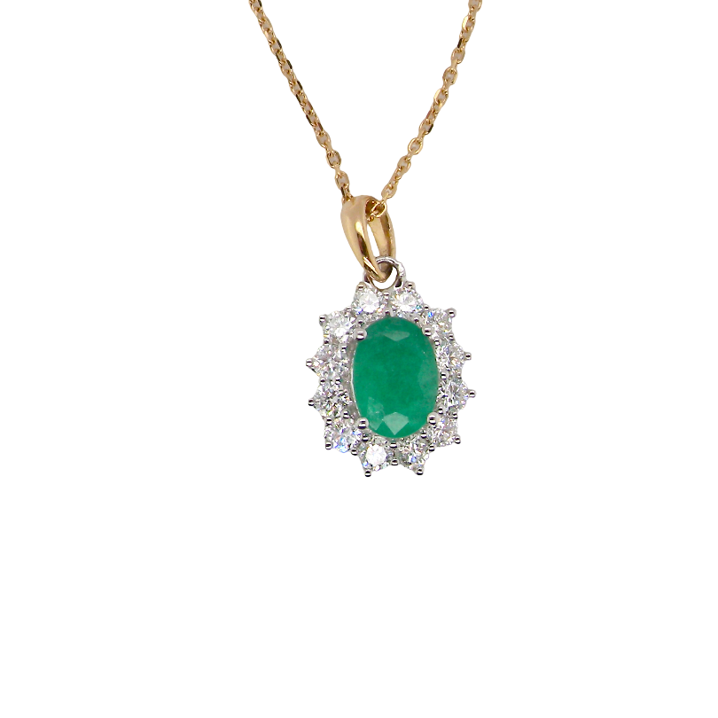 A fine cluster pendant. Features at the centre an oval cut emerald, measures 7.5x5mm (est one carat). Dark green hue, natural inclusions.