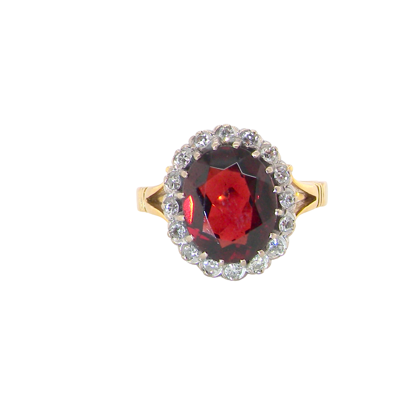 A fine cluster ring. Features a large garnet centre stone
Complimented by an outer halo of brilliant cut diamonds. 