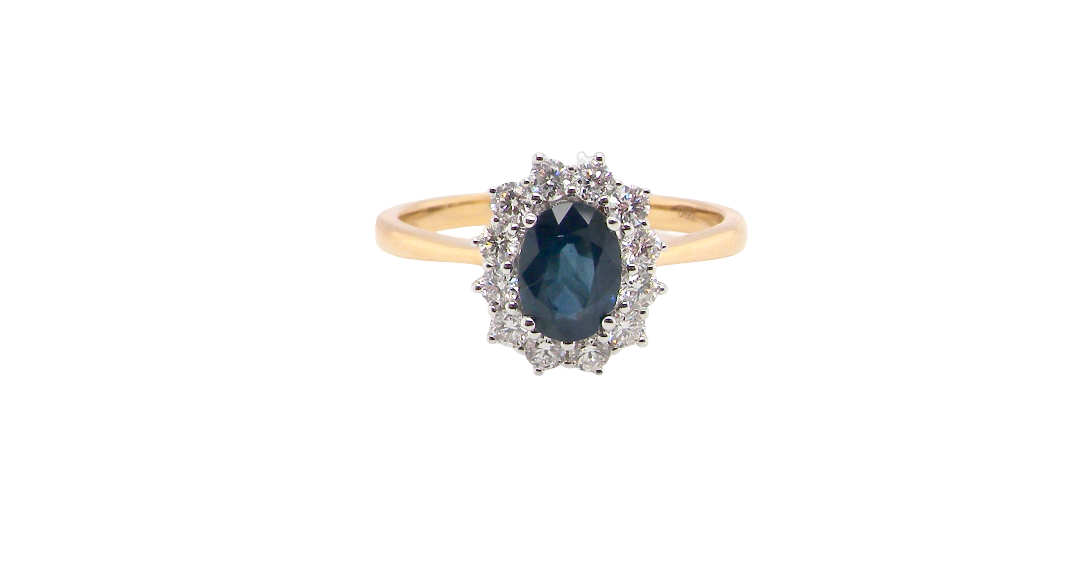 A fine cluster ring that features a black blue oval cut sapphire that measures 7x5mm (est 0.75 carats)