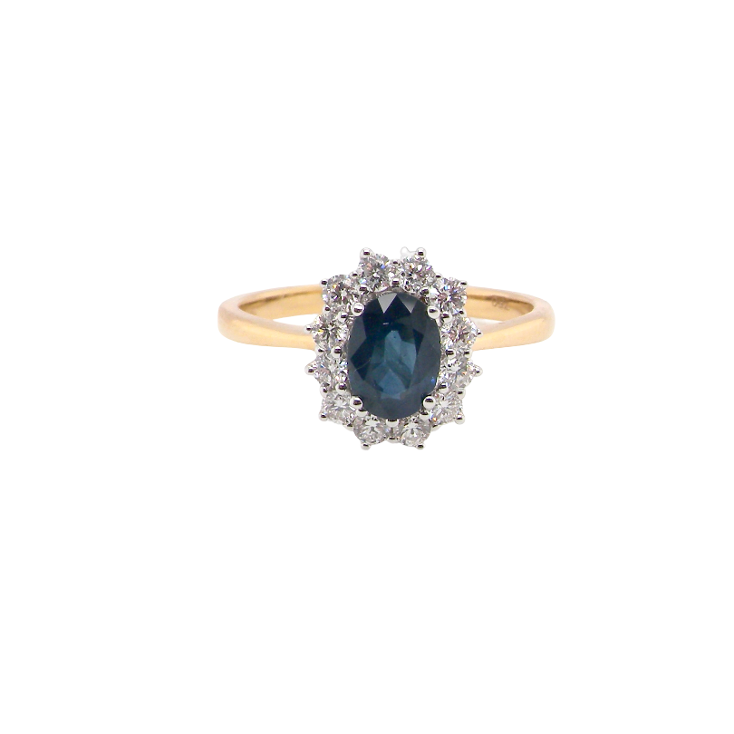 A fine cluster ring that features a black blue oval cut sapphire that measures 7x5mm (est 0.75 carats)