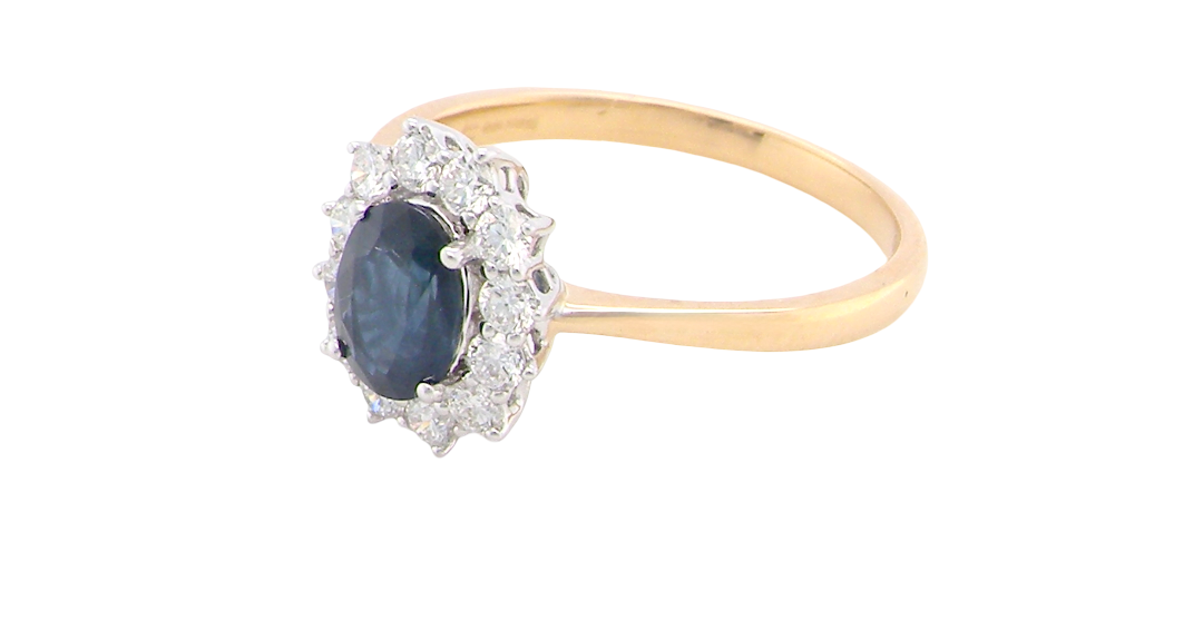 A fine cluster ring that features a black blue oval cut sapphire that measures 7x5mm (est 0.75 carats)
side