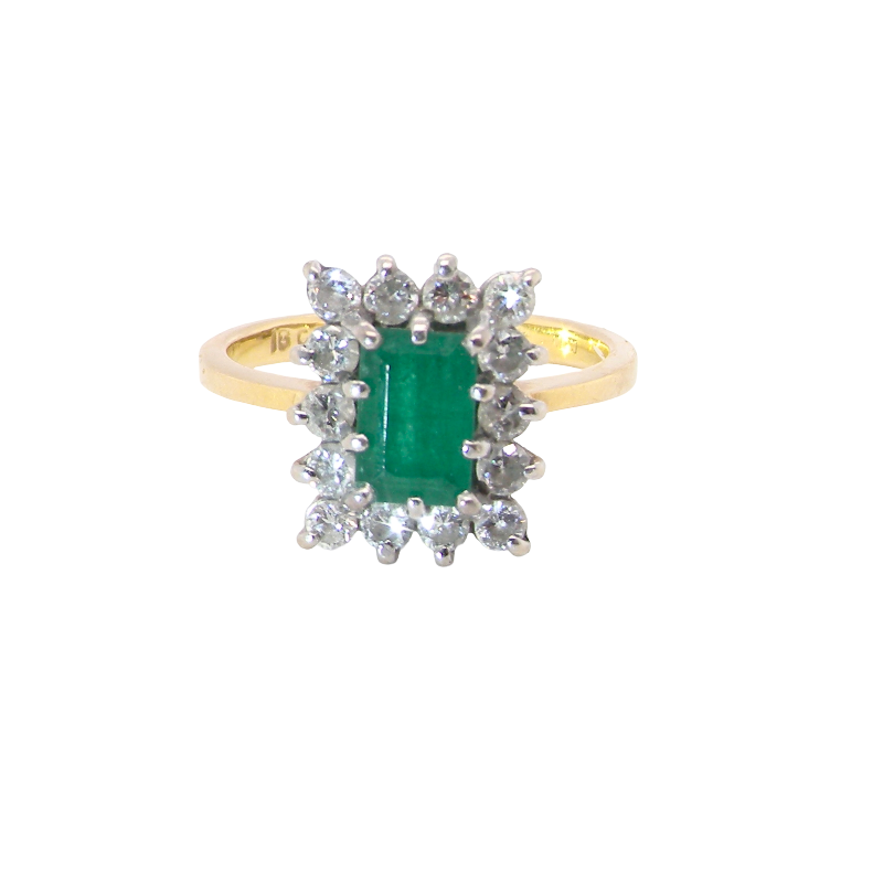 A fine cluster ring that features a rectangular mid to dark green emerald, measures 8x6mm (est 0.50 carats) 