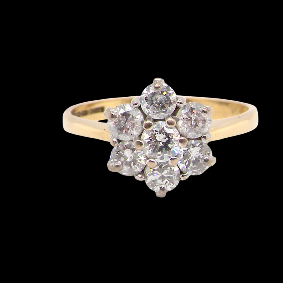 Diamond ring with a yellow gold band on a black background