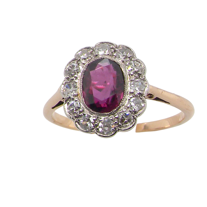 A fine early 20th century cluster ring featuring to the centre an oval ruby, 6x5mm, deep burgundy red colour, mille grain setting.