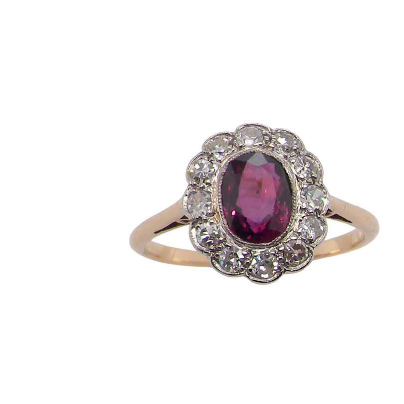 A fine early 20th century cluster ring featuring to the centre an oval ruby, 6x5mm, deep burgundy red colour, mille grain setting. (est 1.02 carats)