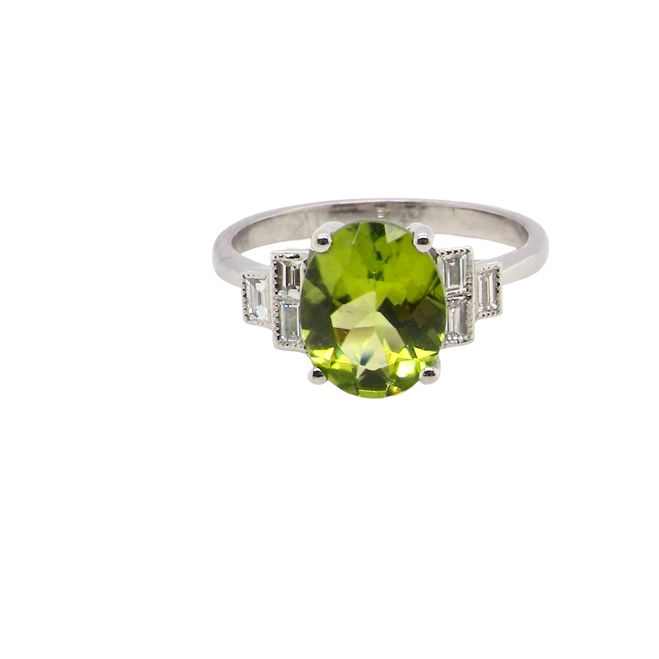 A fine gem set ring featuring a vibrant lime-green oval faceted peridot,