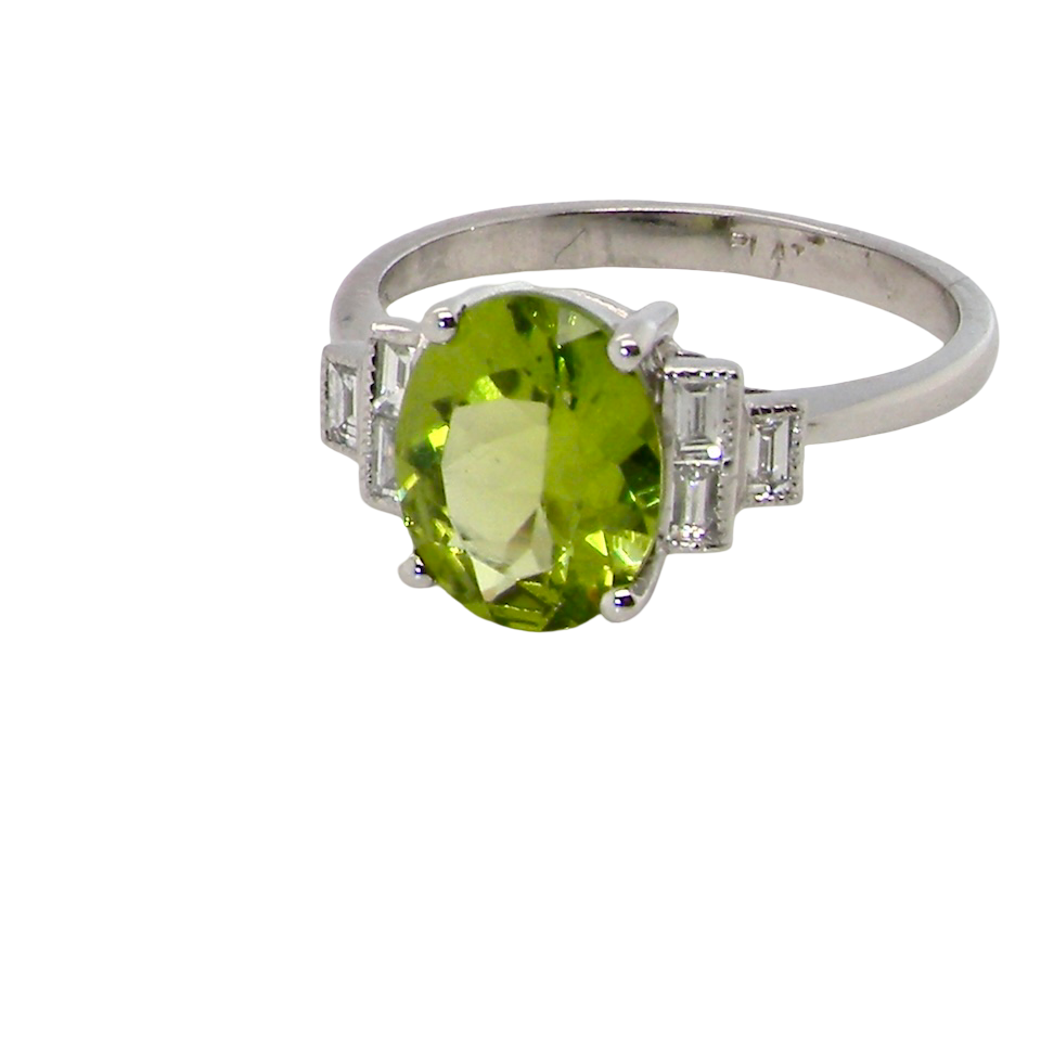 A fine gem set ring featuring a vibrant lime-green oval peridot,