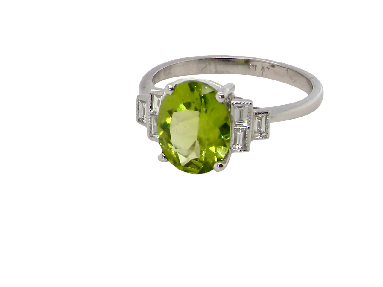 A fine gem set ring featuring a vibrant lime-green oval peridot,