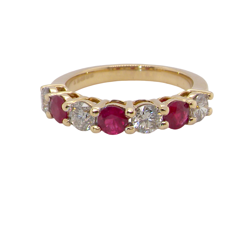 A fine half hoop ring. 18 carat gold set with three rubies, each 3.8mm (est 0.20 carats, total 0.67 carats) and four brilliant cut white diamonds, each 3.8mm
