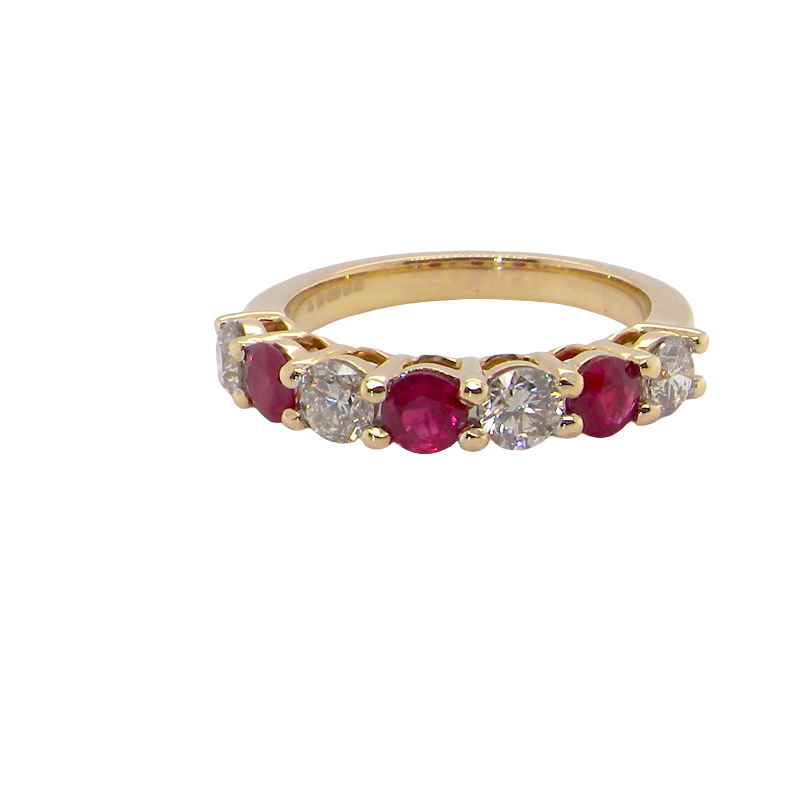 A fine half hoop ring. 18 carat gold set with three rubies, each 3.8mm (est 0.20 carats, total 0.67 carats) and four brilliant cut white diamonds, each 3.8mm (total 0.85 carats) 