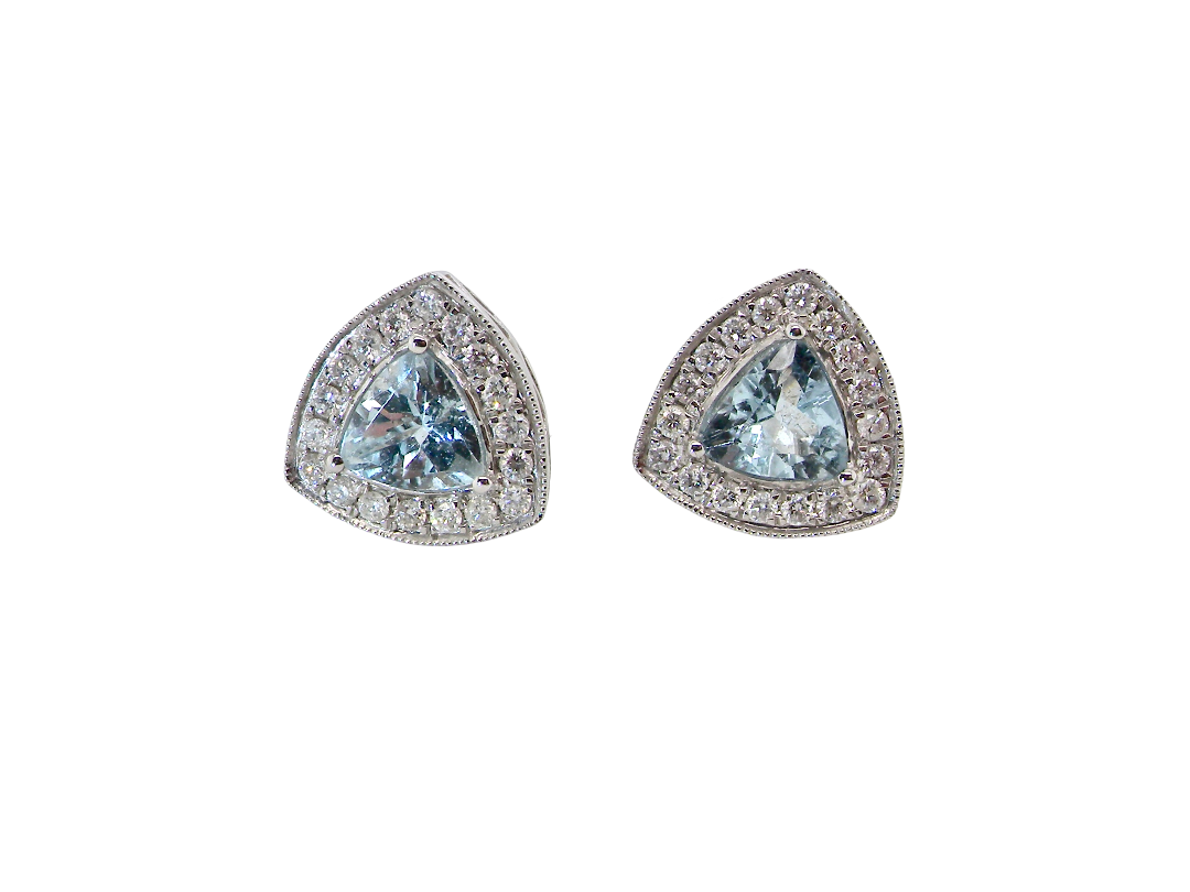 A fine pair of 18 carat white gold cluster earrings, each containing a trapeze cut aquamarine 6x6x6mm (1 carat) surrounded by eighteen x 0.02 carat diamonds