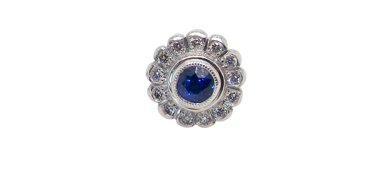 A fine pair of 18 carat white gold sapphire and diamond cluster earring
Each earring is set with a central round sapphire measuring approximately 3.4mm in diameter, estimated at 0.15ct,