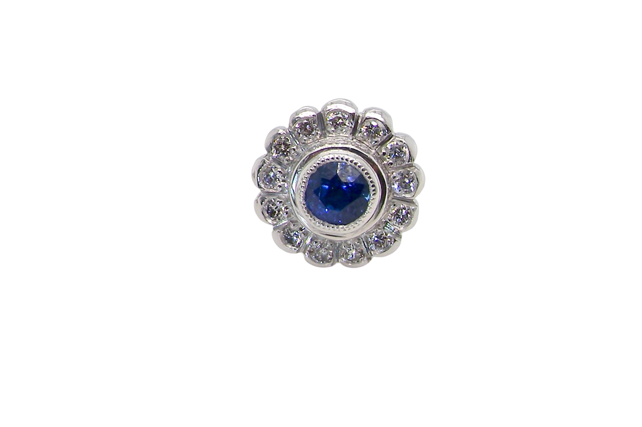 A fine pair of 18 carat white gold sapphire and diamond cluster earring
Each earring is set with a central round sapphire measuring approximately 3.4mm in diameter, estimated at 0.15ct,