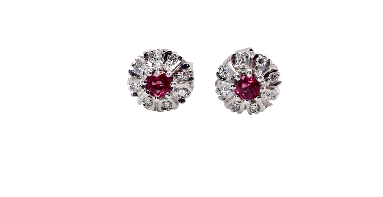 A fine pair of cluster earrings. Features to the centre a round 4.6mm pink sapphire (est 0.38 carats) with a good deep colour hue.
