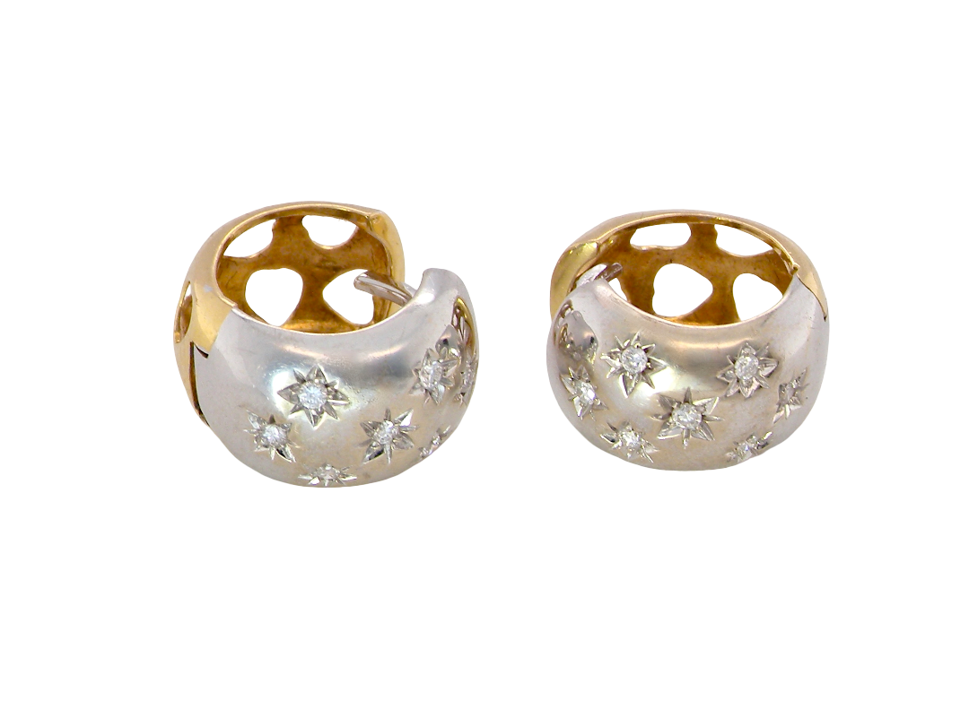 A fine pair of cuff style hoop earrings. The front part is 18 carat white gold * set with seven small white diamonds,