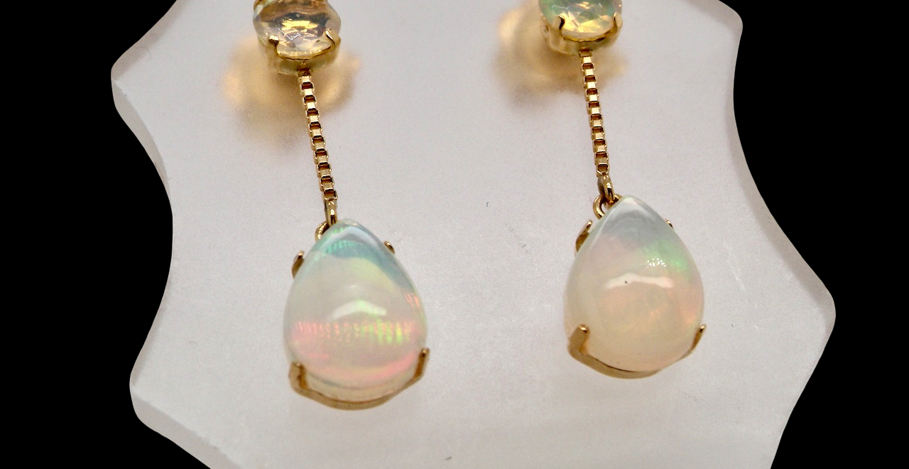 Suspending from a round opal which is at the head of the post, (measures 4mm) a pear shaped opal 8x6mm, and attached to a 9mm box link chain.
