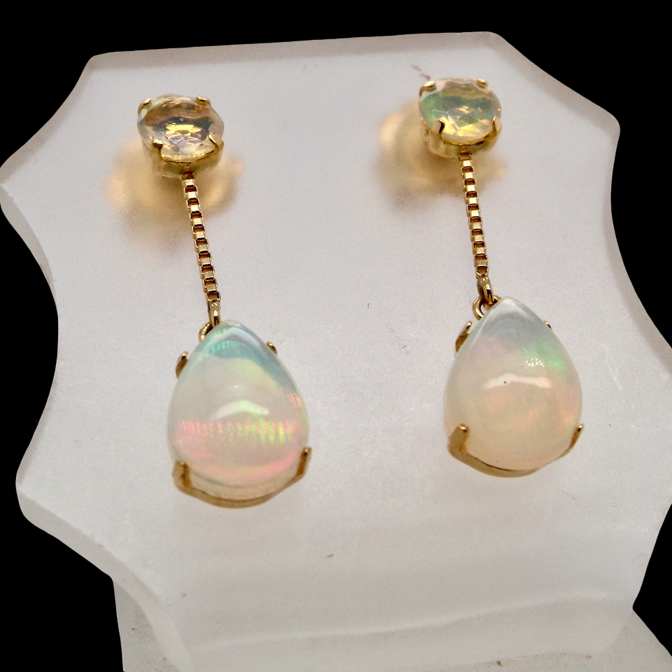 Suspending from a round opal which is at the head of the post, (measures 4mm) a pear shaped opal 8x6mm, and attached to a 9mm box link chain.
