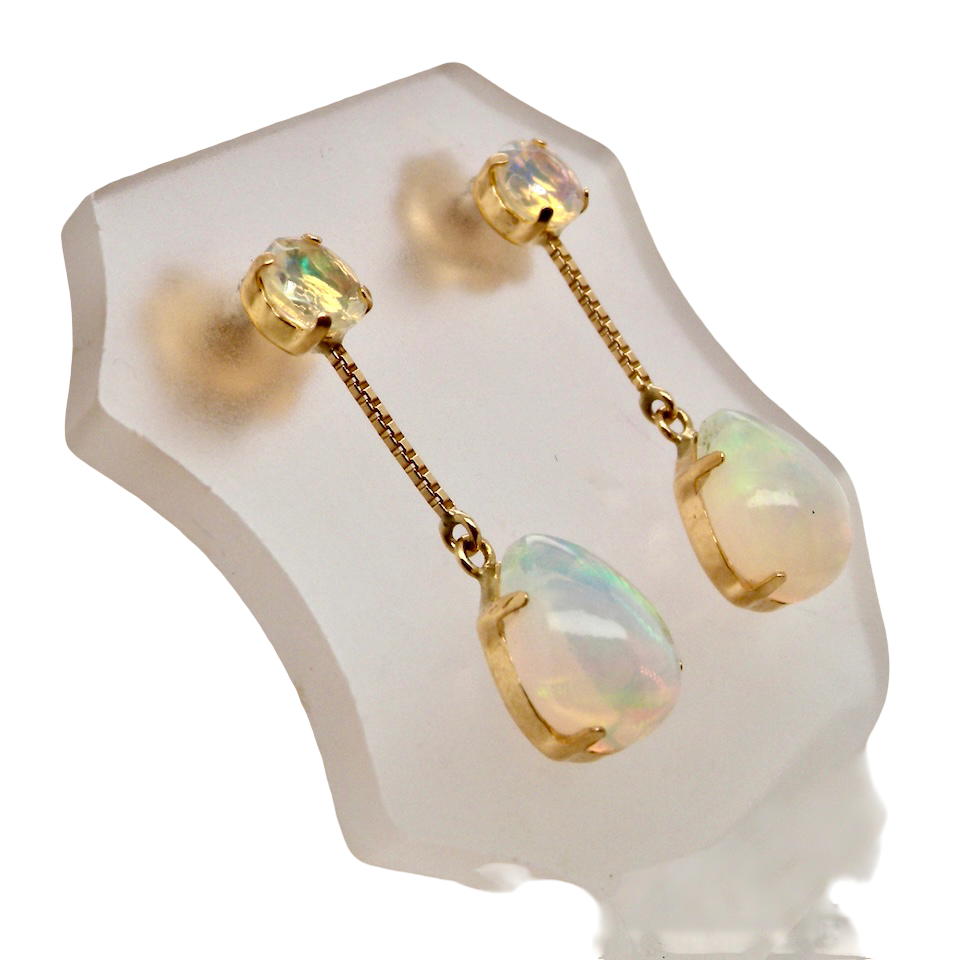 A fine pair of drop earrings. Suspending from a round opal which is at the head of the post, (measures 4mm) a pear shaped opal 8x6mm,