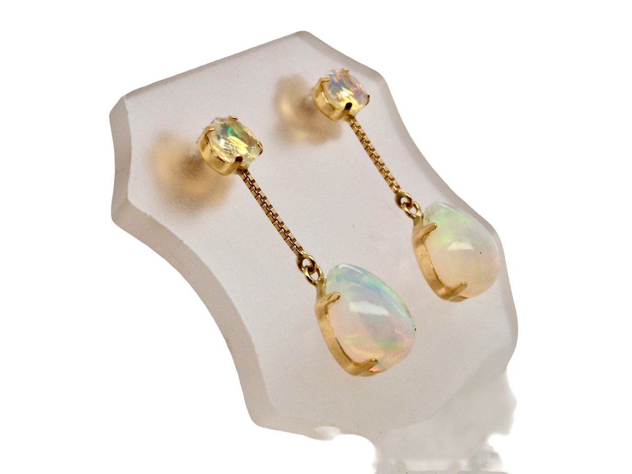 A fine pair of drop earrings. Suspending from a round opal which is at the head of the post, (measures 4mm) a pear shaped opal 8x6mm,