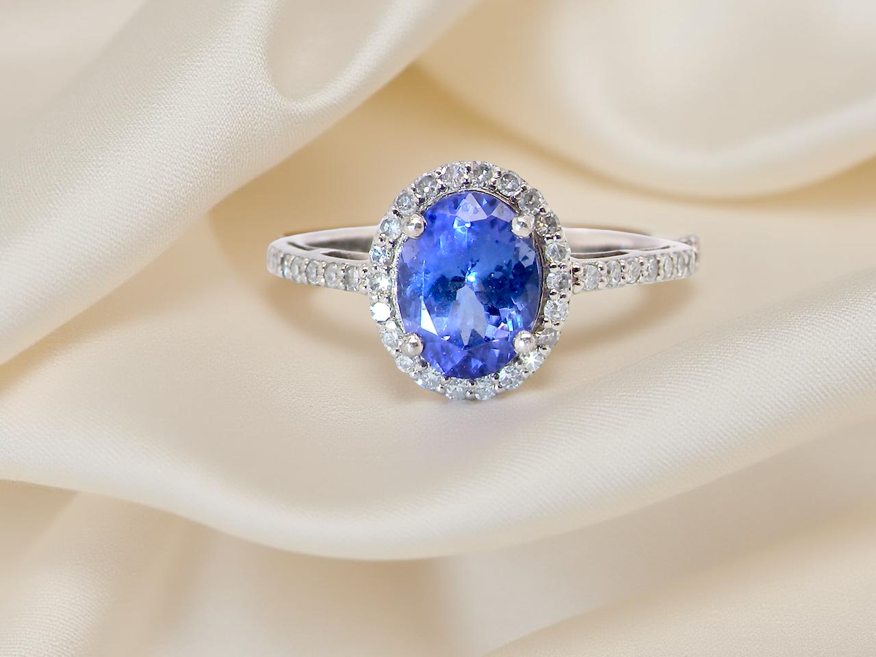 A platinum cluster ring showcasing a vibrant AAA tanzanite B
