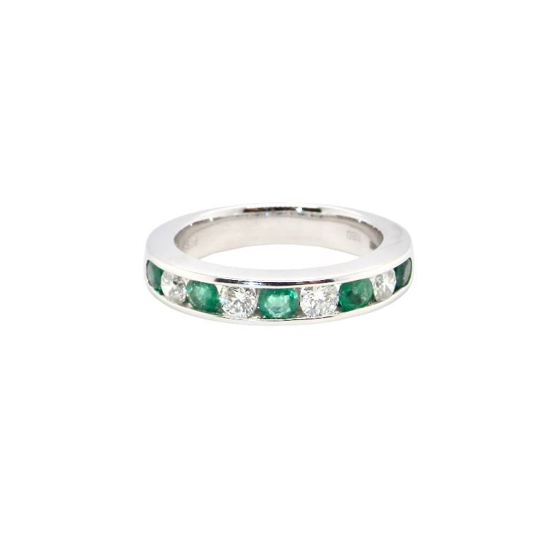 A fine platinum half hoop eternity ring. This is a new ring*. Channel set gem stones, five bright green emeralds 2.6mm each (0.54 carats total)