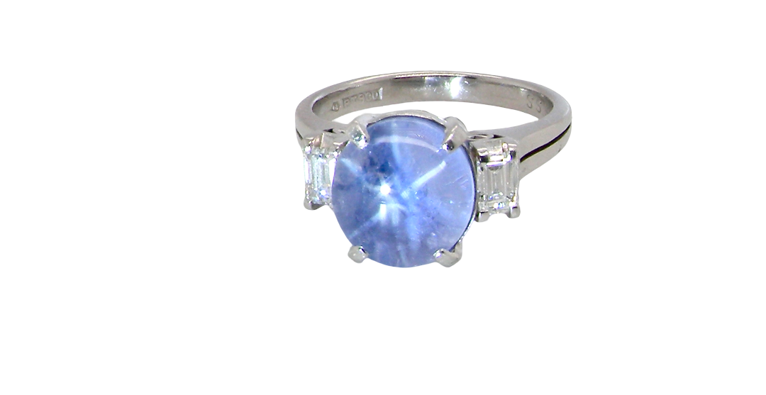 A fine platinum* ring. Features a lovely sky blue sapphire with 'star sapphire ' chatoyancy , measures 10x9mm, (est 4 carats) held by four claws, cabouchon cut