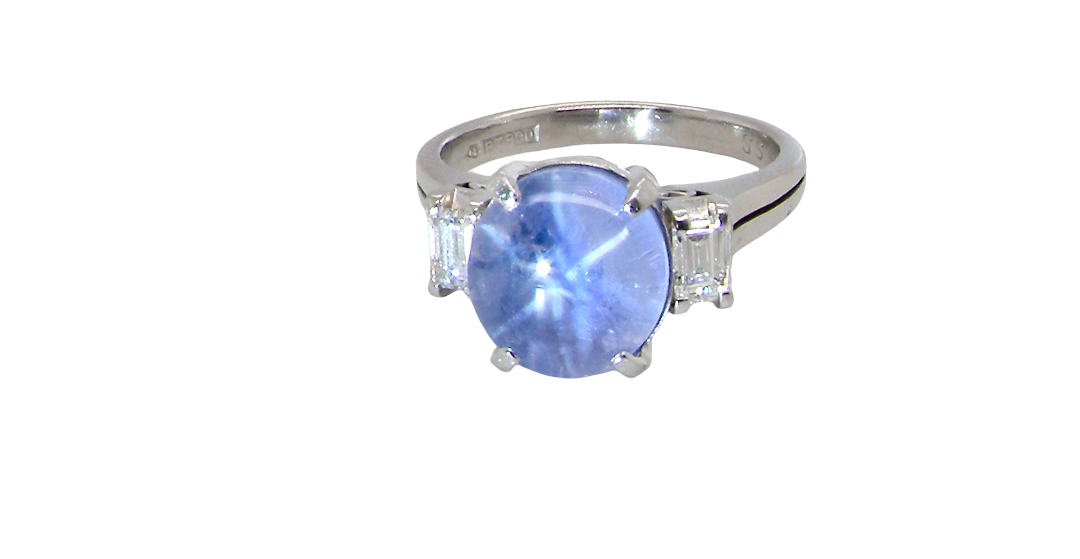 A fine platinum* ring. Features a lovely sky blue sapphire with 'star sapphire ' chatoyancy , measures 10x9mm, (est 4 carats) held by four claws, cabouchon cut