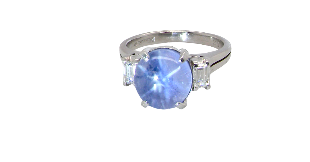 A fine platinum* ring. Features a lovely sky blue sapphire with 'star sapphire ' chatoyancy , measures 10x9mm, (est 4 carats) held by four claws, cabouchon cut