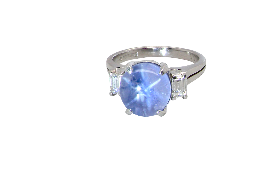 A fine platinum* ring. Features a lovely sky blue sapphire with 'star sapphire ' chatoyancy , measures 10x9mm, (est 4 carats) held by four claws, cabouchon cut
