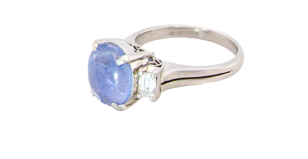 A fine platinum* ring. Features a lovely sky blue sapphire with 'star sapphire ' chatoyancy , measures 10x9mm, (est 4 carats)