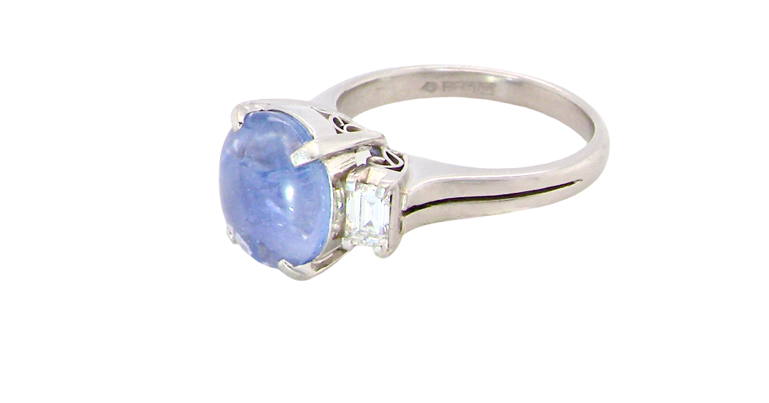 A fine platinum* ring. Features a lovely sky blue sapphire with 'star sapphire ' chatoyancy , measures 10x9mm, (est 4 carats)