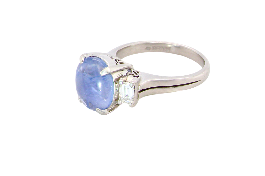 A fine platinum* ring. Features a lovely sky blue sapphire with 'star sapphire ' chatoyancy , measures 10x9mm, (est 4 carats)
