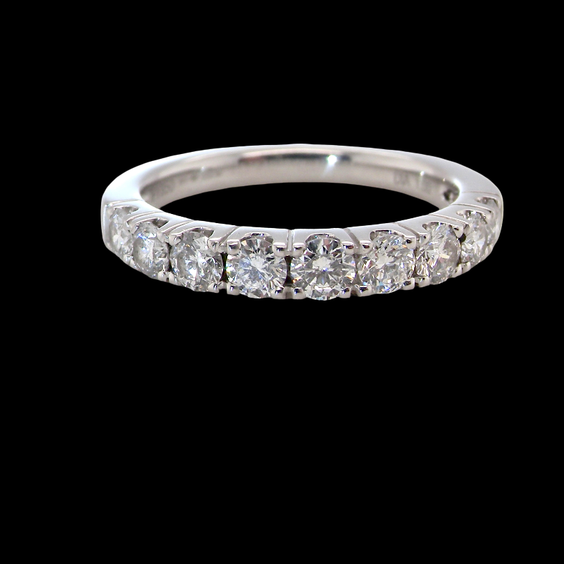 A fine seven stone half hoop platinum eternity ring,