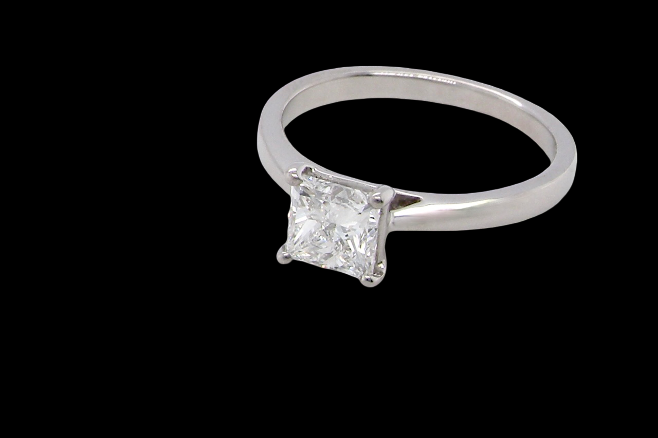 A fine solitaire ring featuring a square cut diamond of excellent quality.
Superb colour grade of E, excellent clarity- graded VVS2*. Stone measures 5x5x3.68, 0.83 carats.