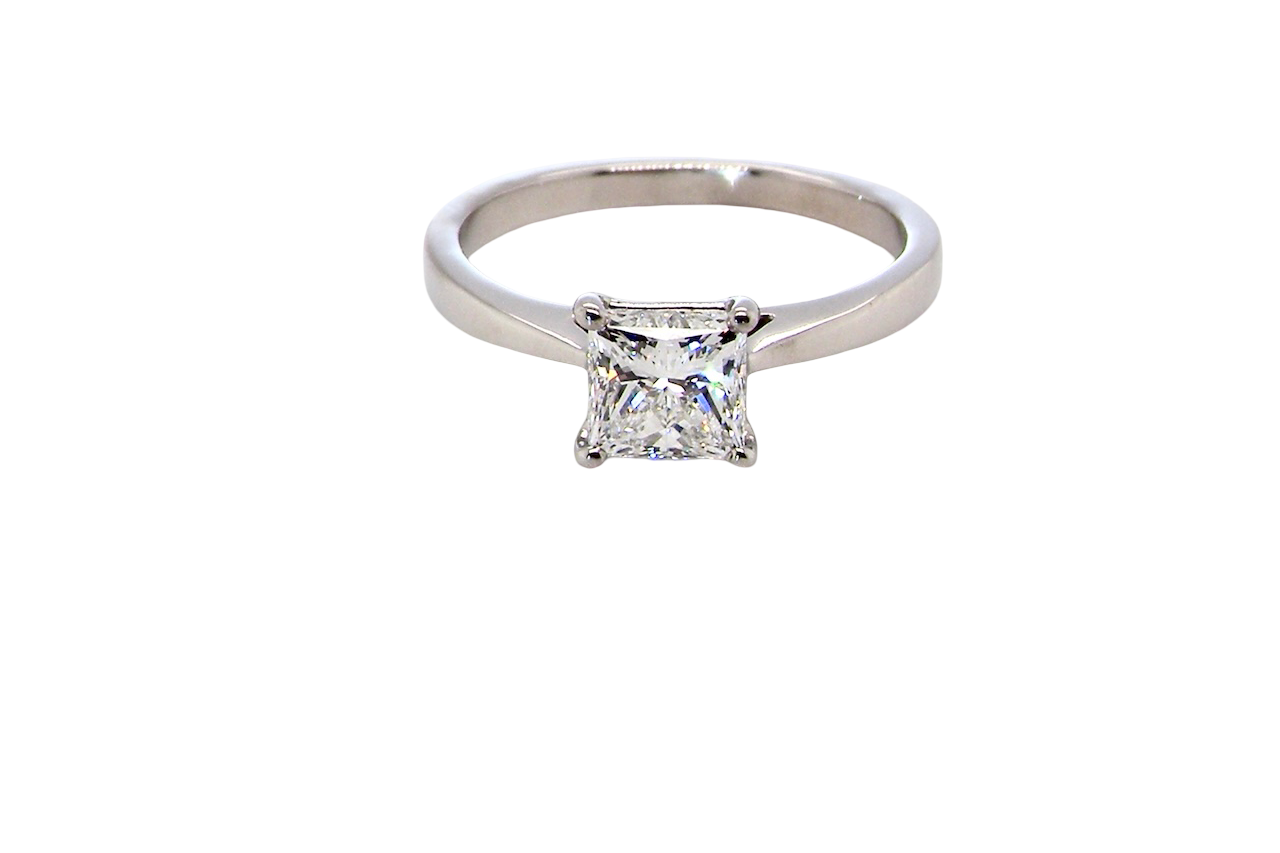 A fine solitaire ring featuring a square cut diamond of excellent quality.
Superb colour grade of E, excellent clarity- graded VVS2*. Stone measures 5x5x3.68, confirmed as 0.83 carats.