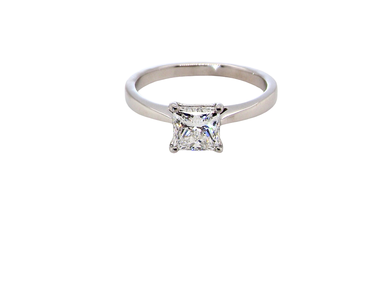 A fine solitaire ring featuring a square cut diamond of excellent quality.
Superb colour grade of E, excellent clarity- graded VVS2*. Stone measures 5x5x3.68, confirmed as 0.83 carats.