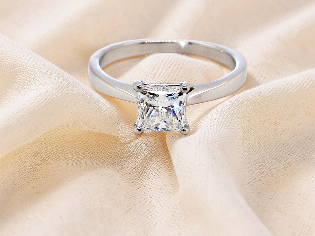 A fine solitaire ring featuring a square cut diamond of excellent quality.
Superb colour grade of E, excellent clarity- graded VVS2*. confirmed as 0.83 carats.