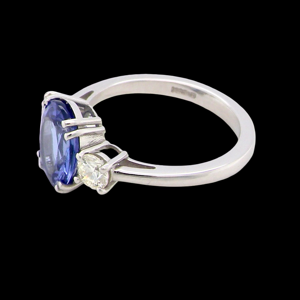 A fine three stone trilogy ring. The centre stone a 4A tanzanite gem stone, measures (est 3 carats) 