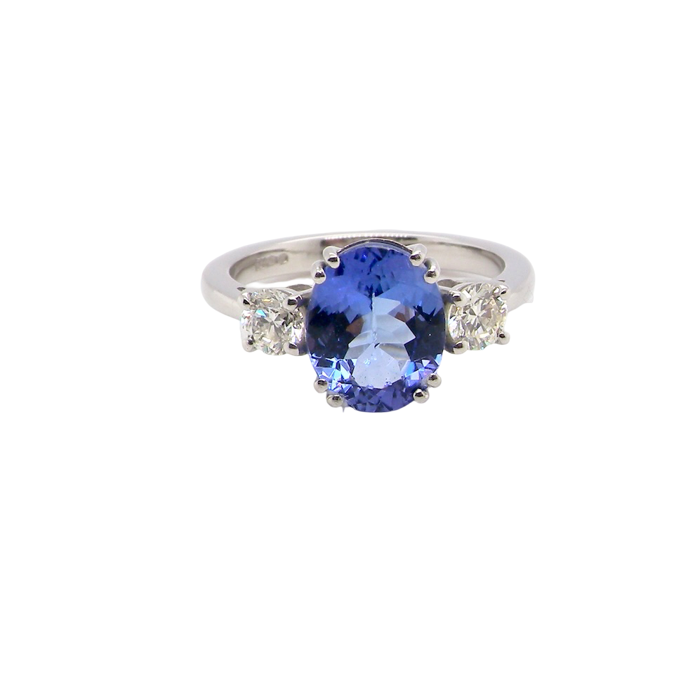 A fine three stone trilogy ring. The centre stone a 4A tanzanite gem stone, measures 10x8mm (est 3 carats) 
