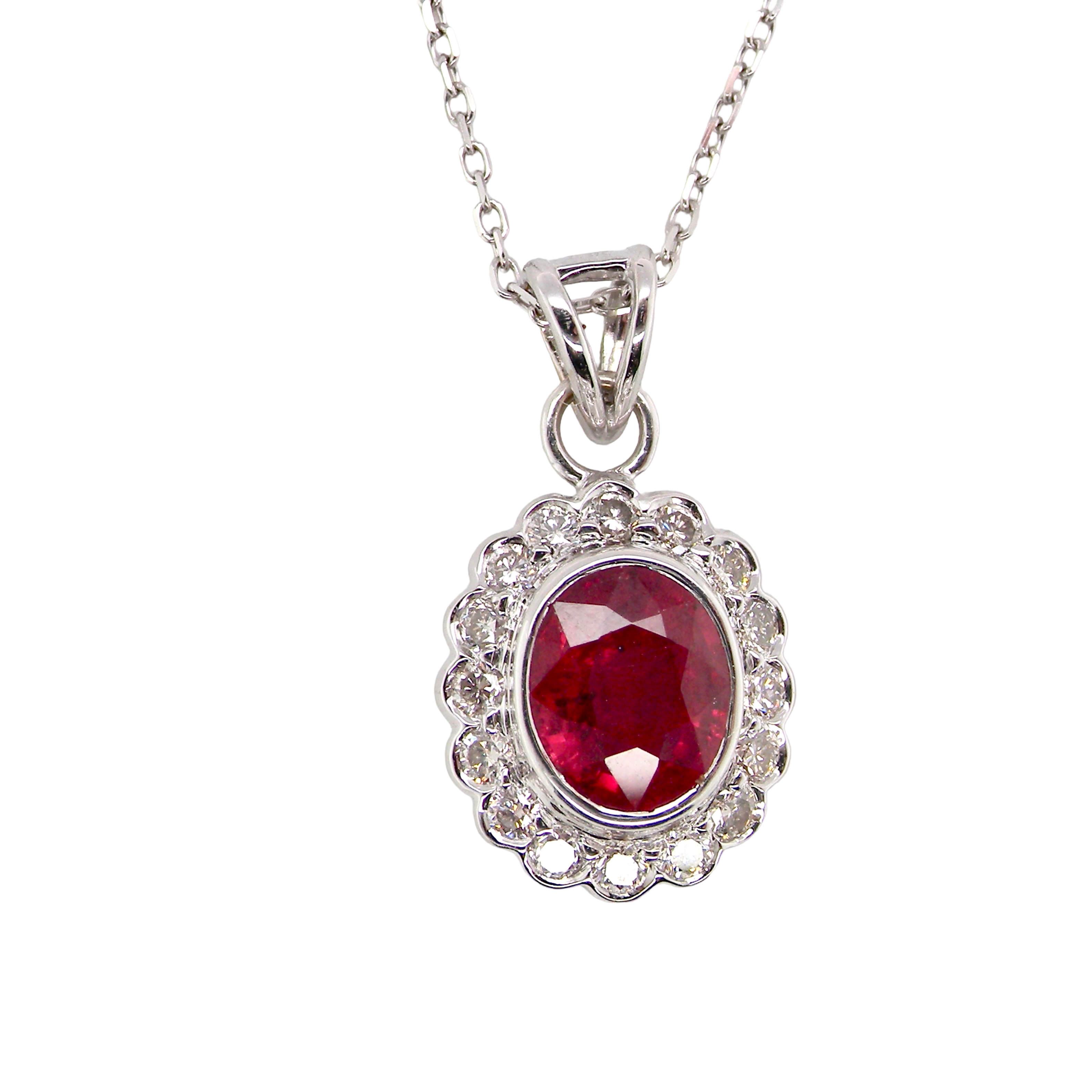 A fine white gold pendant that features to the centre an oval facet cut ruby, 8x6mm (est 1.25 carats)
