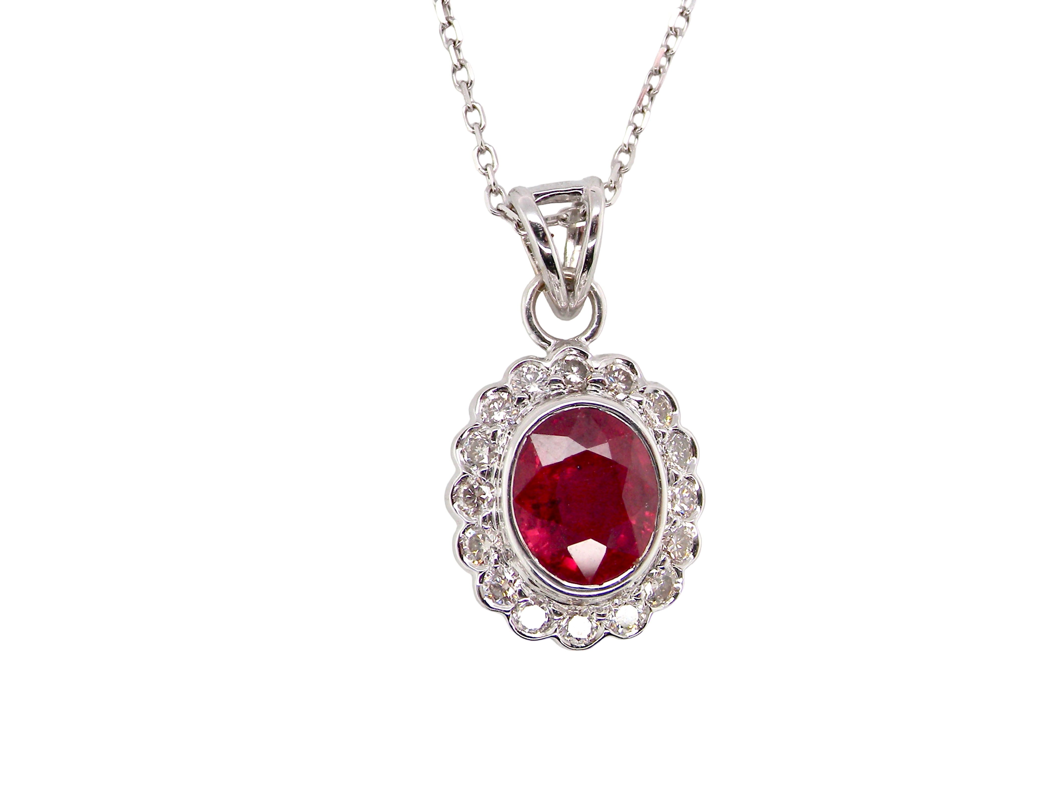 A fine white gold pendant that features to the centre an oval facet cut ruby, 8x6mm (est 1.25 carats)