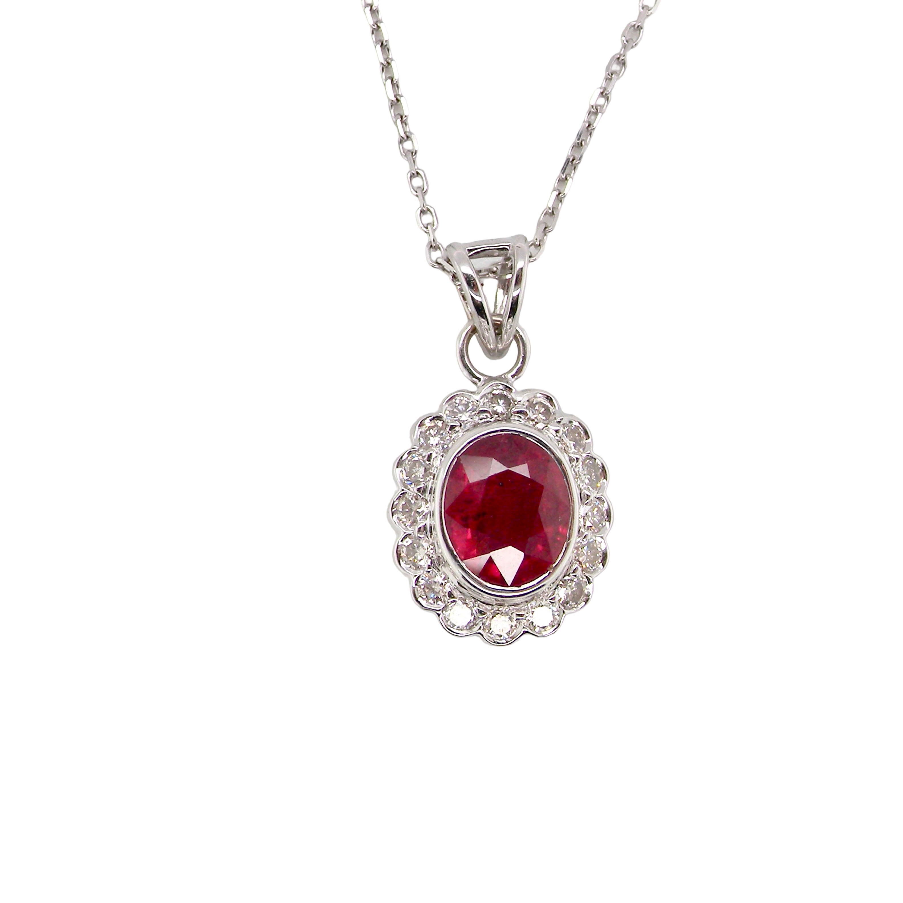 A fine white gold pendant that features to the centre an oval facet cut ruby, 8x6mm (est 1.25 carats) good deep red colour.